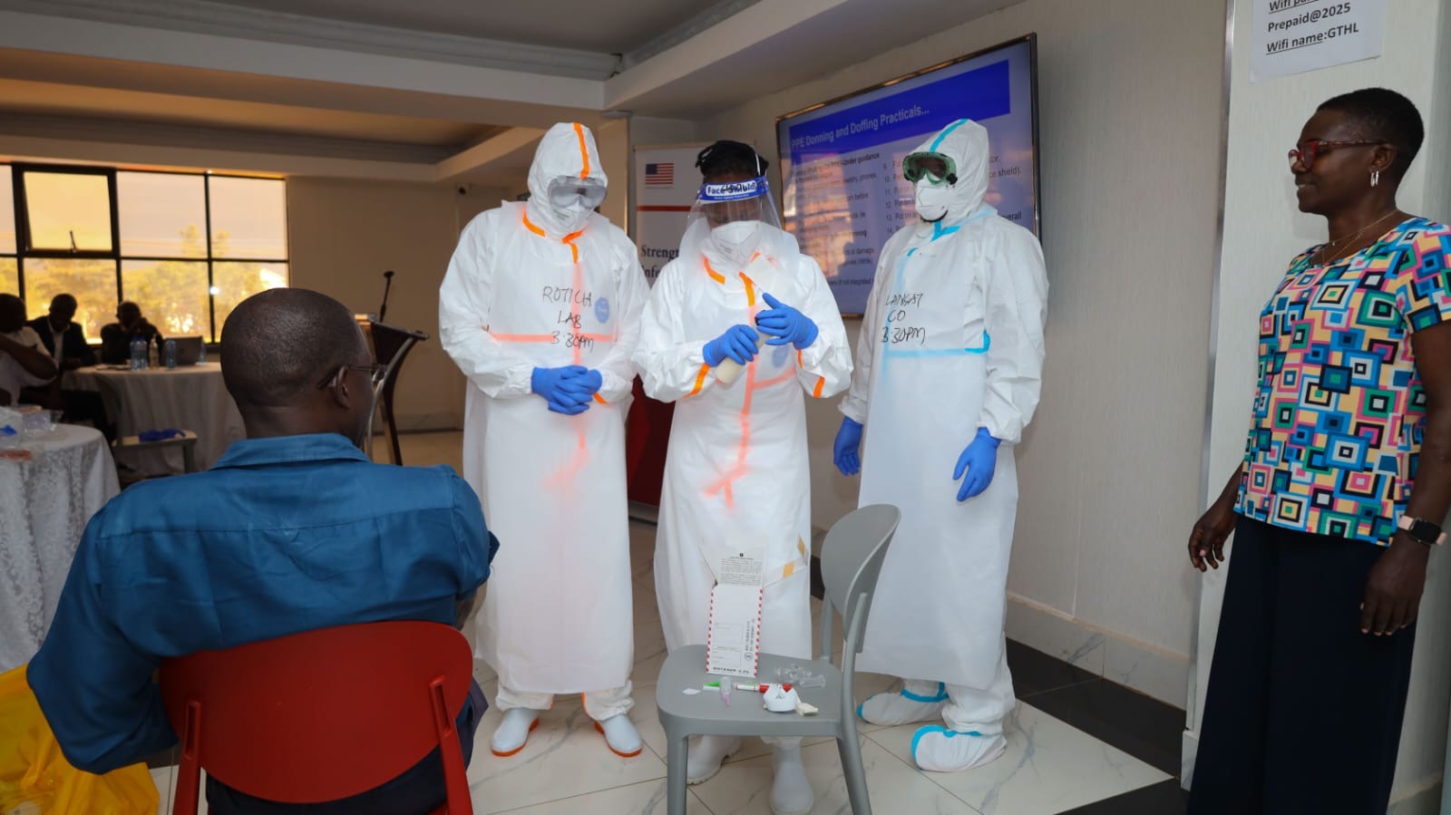 Kenya National Public Health Institute (KNPHI) staff demonstrating PPE donning and doffing practical training session ahead of potential Ebola outbreak in the country.