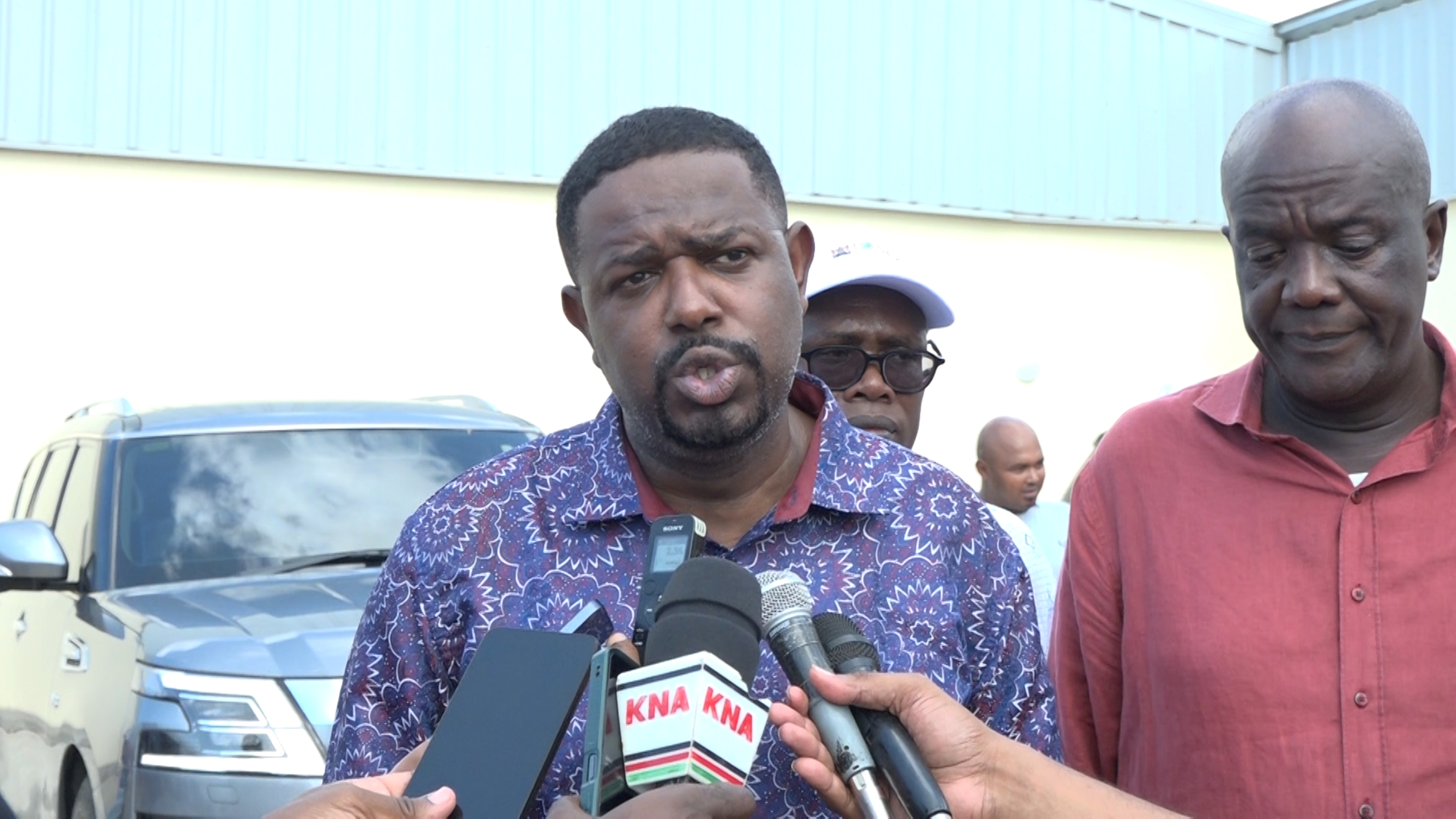 Investment Promotion Principal Secretary Abubakar Hassan Abubakar addresses journalists after the official opening of the Milly Fruit Processing Factory in Sabaki Ward of Magarini Constituency, Kilifi County. He is flanked by Kilifi County Governor Gideon Mung’aro.