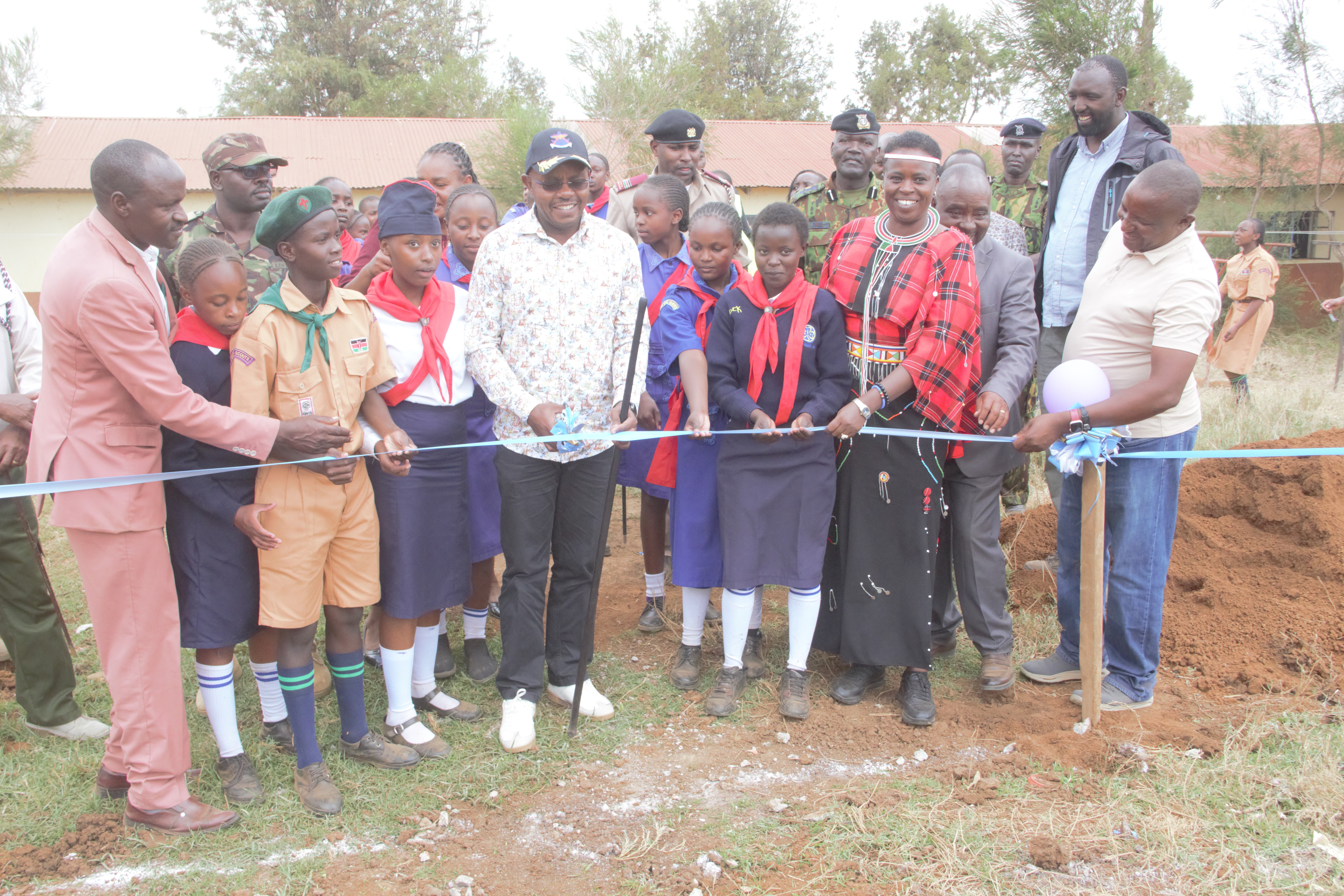 Defence PS Patrick Mariru (with cap) and Laikipia North Member of Parliament Sarah Korere (Second Right) cutting a ribbon for the commencement of dormitory construction in Ngenia Comprehensive School.