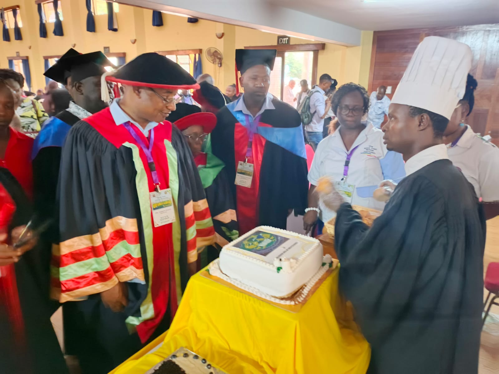  Director of TVET Dr. Joseph Kanyi (in red and black) inspects a cake decorated by one of the Recognition of Prior Learning graduates during the graduation ceremony at Kenya Coast National Polytechnic in Mombasa.