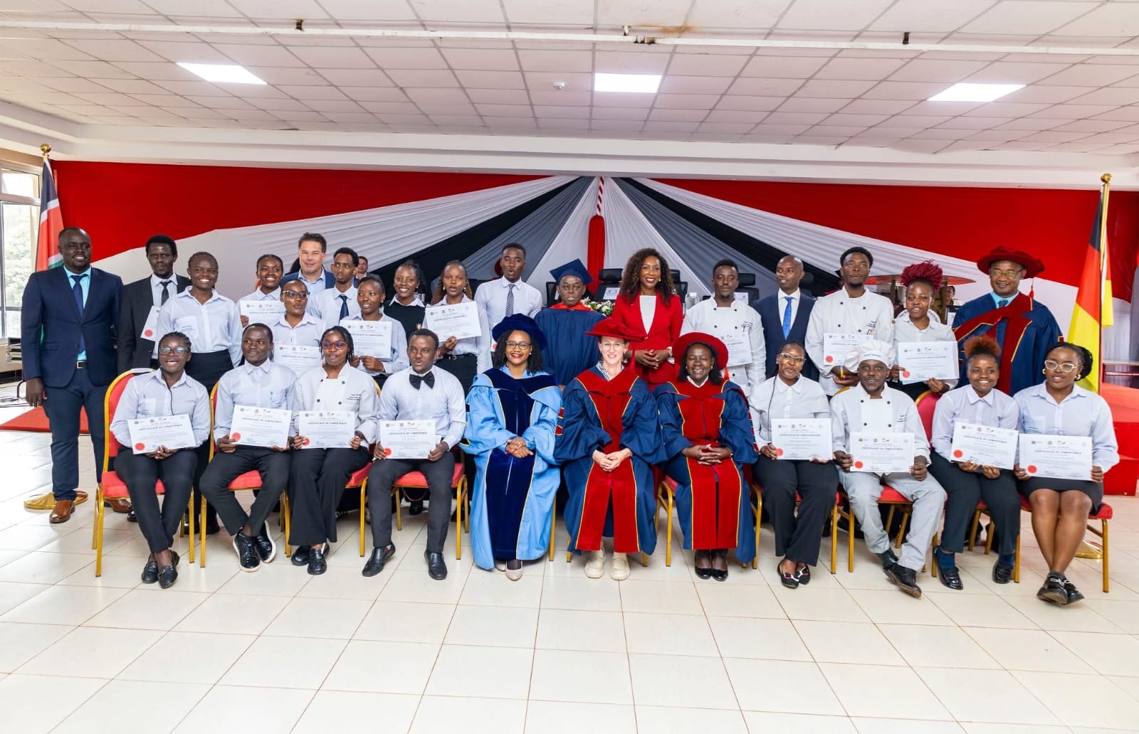 Graduates pose with government officials after the ceremony.