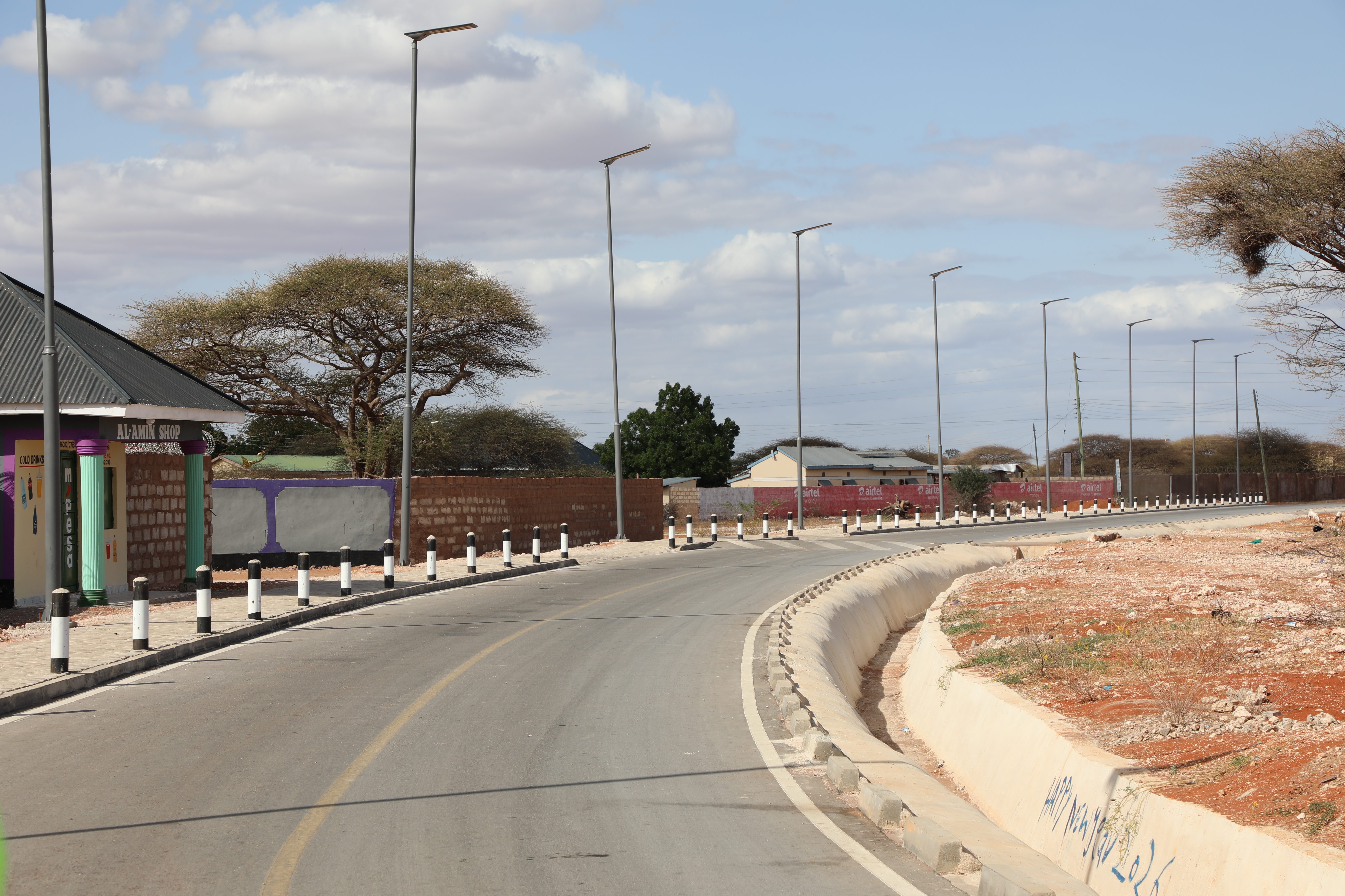 A newly constructed road with storm water drainage and solar-powered streetlights under KISIP II in Wajir Municipality.