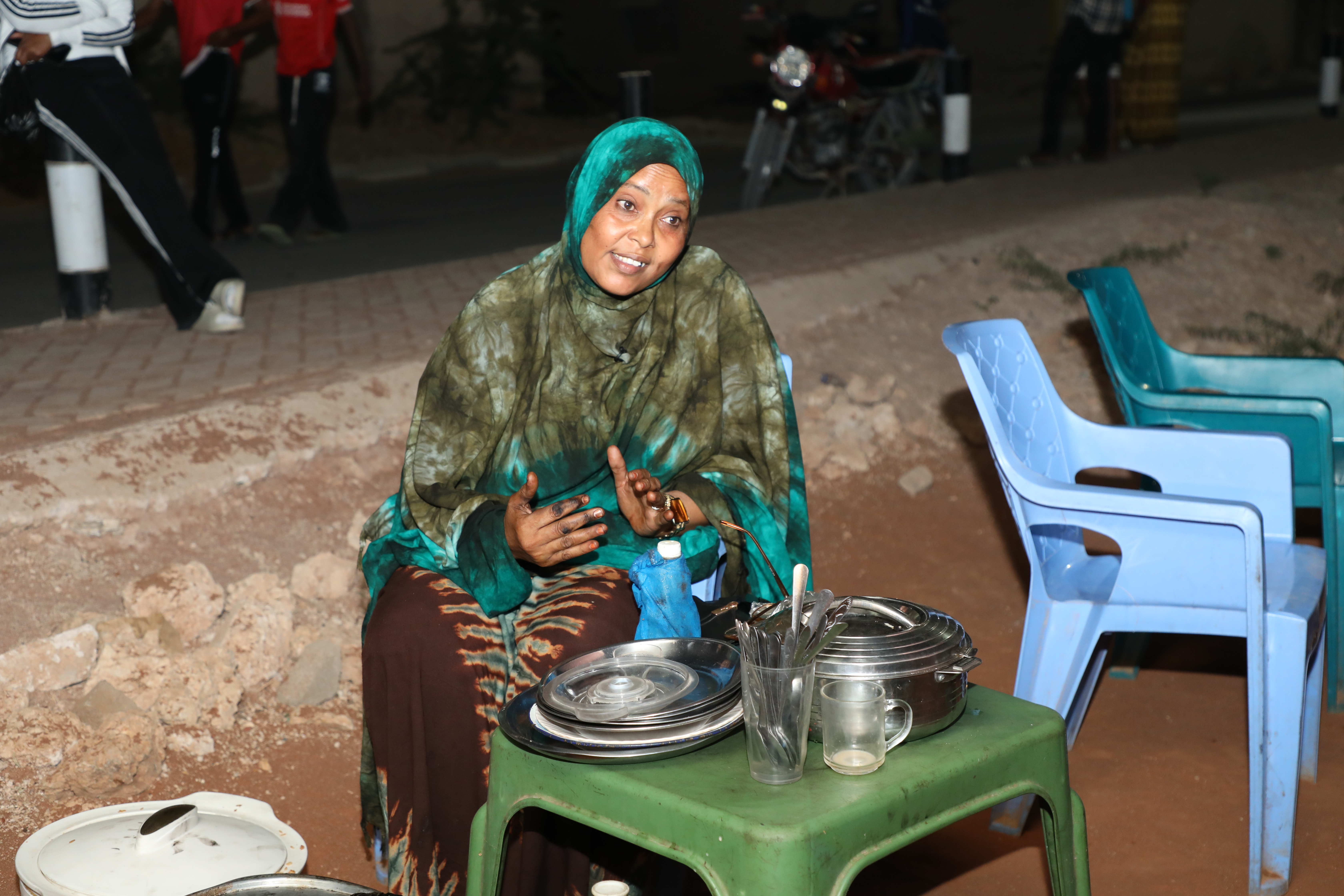 Roadside food vendor Fatuma Aliada explains how improved street lighting under KISIP II has enabled her to operate longer hours and increase her income in Borwaqo Settlement.