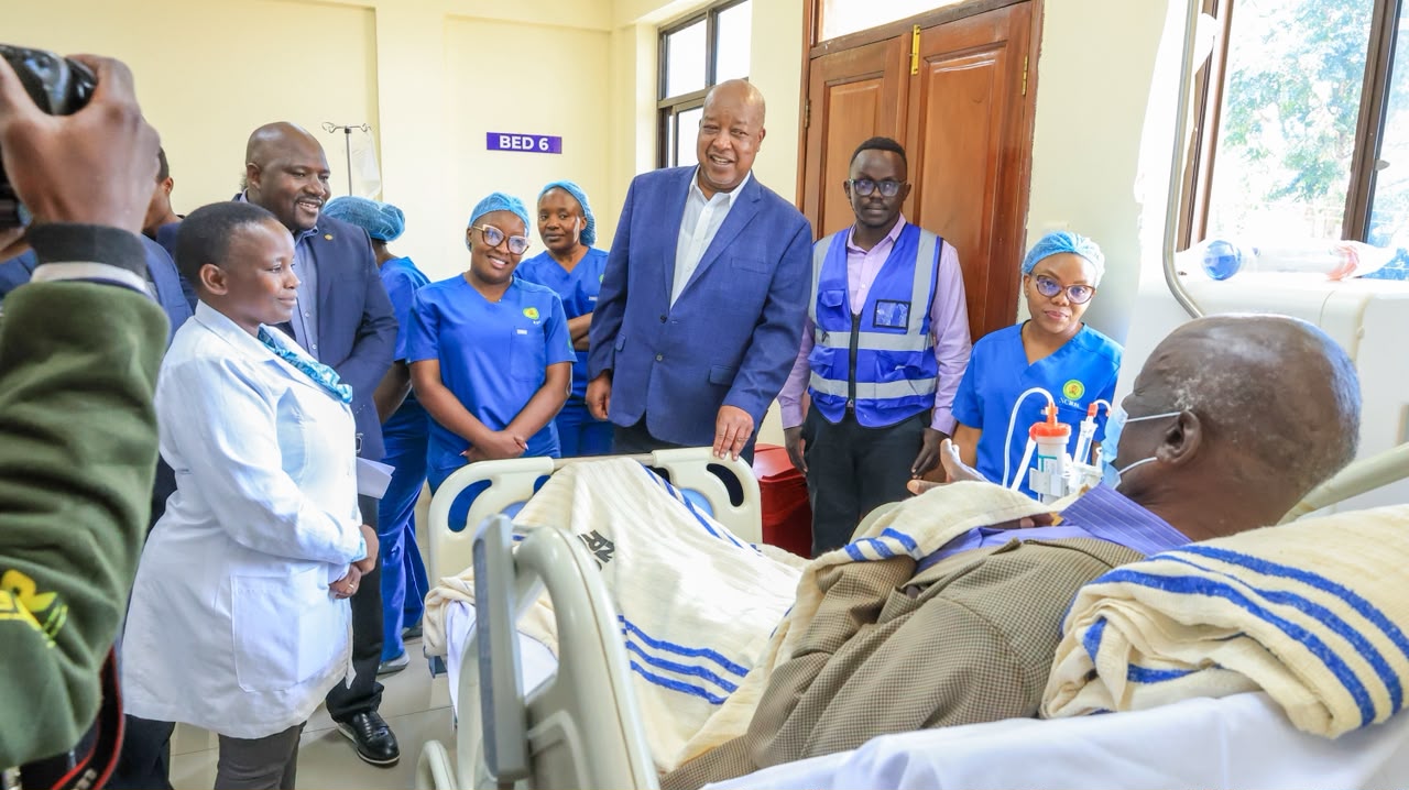 Nyamira Governor Amos Nyaribo speaks to a patient who is undergoing a dialysis session with the dialysis machines procured and launched by his government to improve services at the renal unit of Nyamira referral hospital