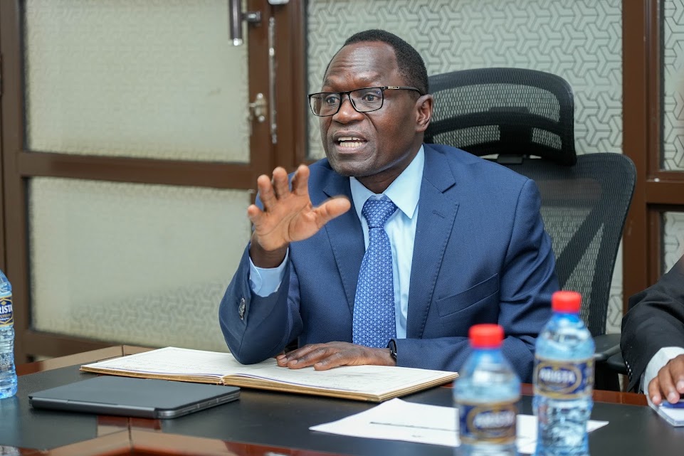 Principal Secretary for Sports, Elijah Mwangi, speaks during a stakeholder meeting at Talanta Stadium, reaffirming the government's commitment to completing the facility on schedule for the 2027 AFCON tournament