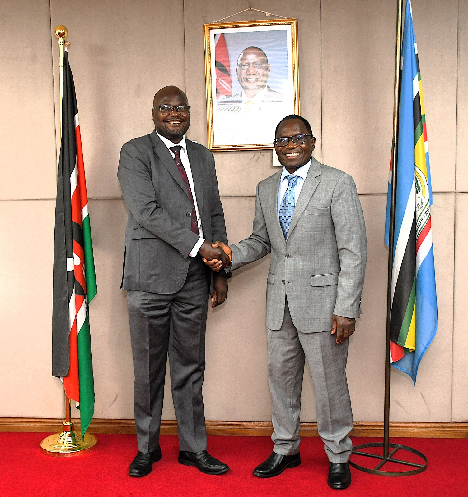 State Department for Broadcasting and Telecommunications Principal Secretary Mr. Stephen Isaboke (right) greeting Commissioner for ICT Infrastructure Development at the Ministry of ICT & National Guidance in Uganda and Uganda Communications Commission (UCC) Board Member Eng. Geoffrey Agoi. Photo by Cheptumo Kibet.