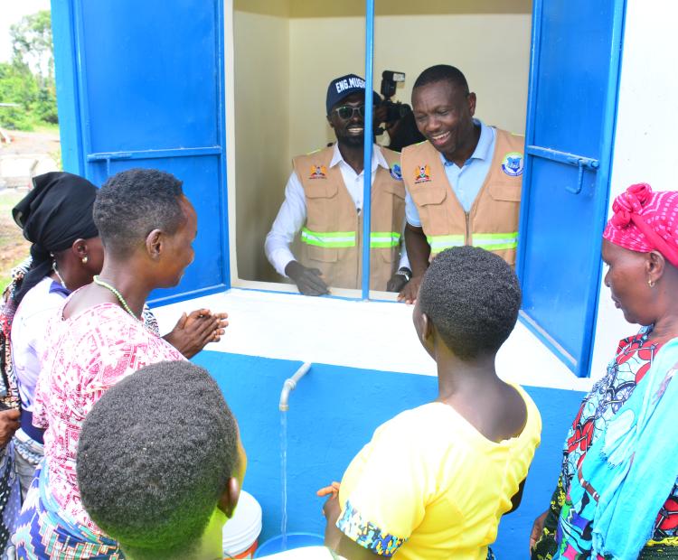 Engineer Mugaa (in cap) and Kuria East Member of Parliament Maisori Kitayama during the Commissioning of a water kiosk at the Kegango Cluster water and Sanitation project ( lot 1-Nyamanche water supply) in Kuria East Sub-County. PHOTOS: MAKOKHA KHAOYA