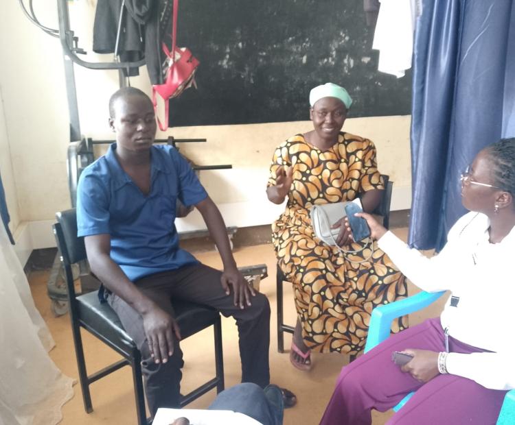 Isaac Chabeda, a 19-year-old mental health patient from Busamu, Vihiga County, shares a moment with his mother, Margaret Kadara, during a clinic review at Vihiga Teaching and Referral Hospital. Kadara says timely medical care, counselling and family support have contributed to her son's gradual recovery. Photo by Kelly Barasa.   