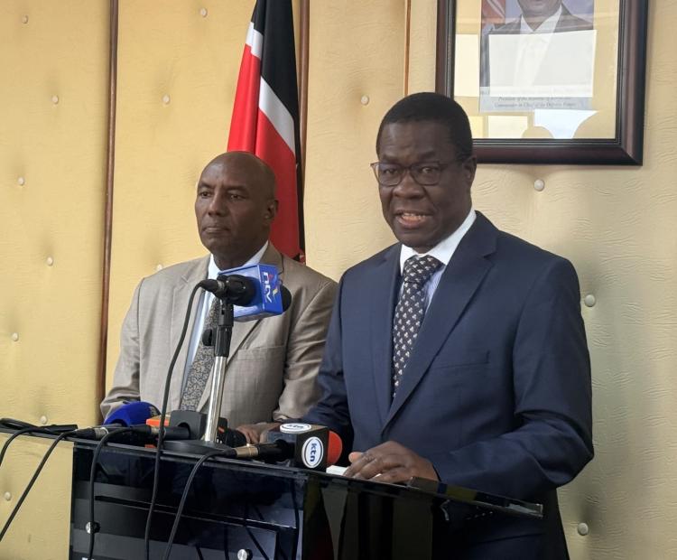 Energy and Petroleum Cabinet Secretary Opiyo Wandayi (right) speaking on global energy markets at KASNEB Towers in Nairobi.